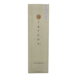 A tall, slim bottle of Tatcha The Essence Plumping Skin Softener with a beige label and a small decorative pattern on the lower right corner.